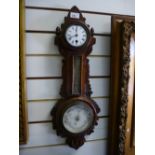 A carved oak aneroid barometer, thermometer and clock