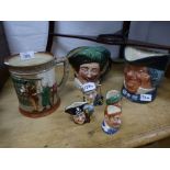 A Royal Doulton 'Oliver Twist' tankard and six character jugs