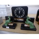 A 1930's marble clock garniture, the bookends decorated of a deer
