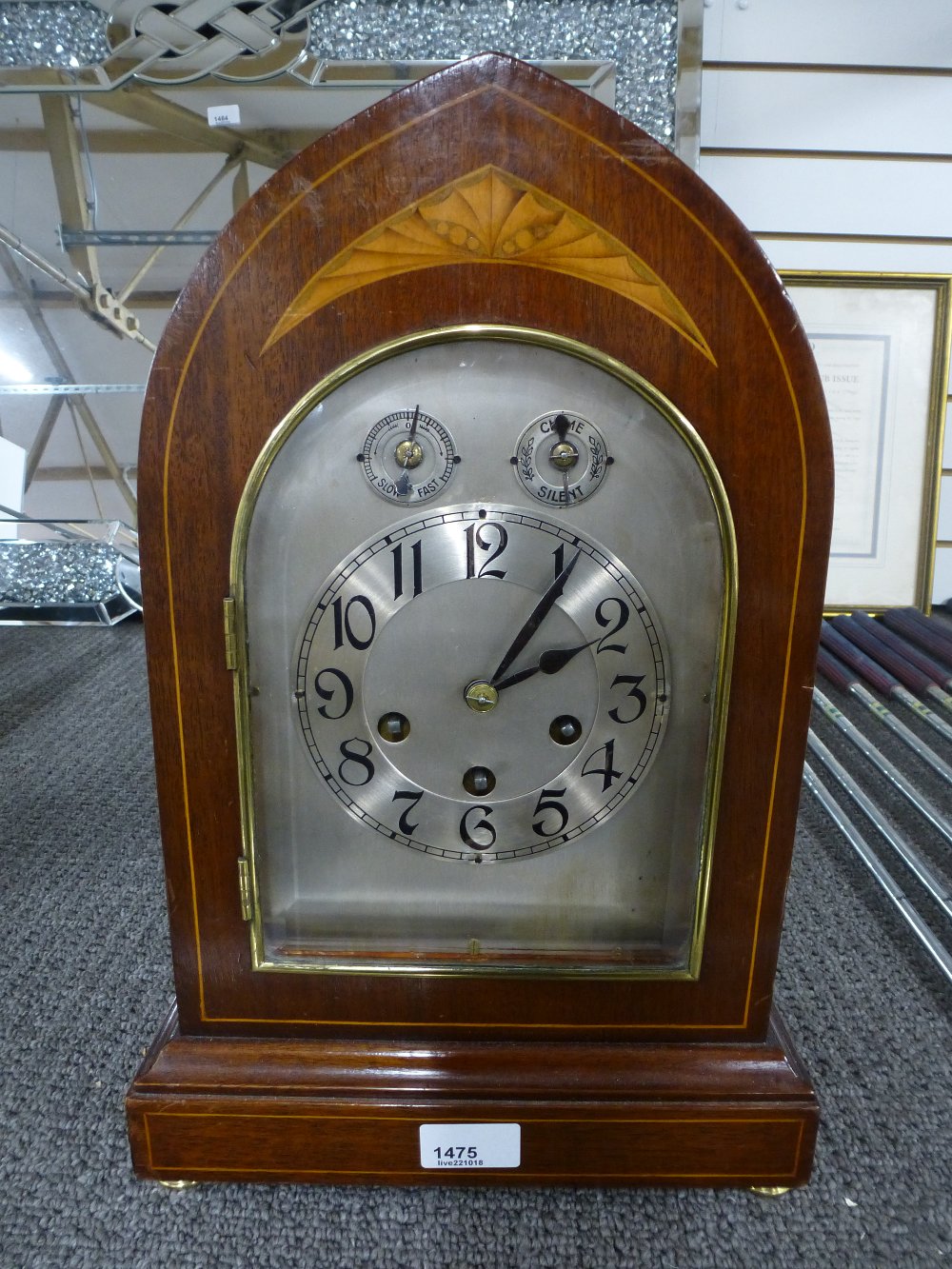 An Edwardian inlaid mahogany chiming mantle clock with an arched top, 41cms