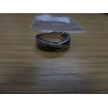 Modern 18K white gold ring inset with black and white diamonds, shank stamped 18K, size Q/R