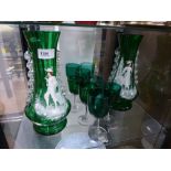 A pair of Mary Gregory green glass vases and seven Victorian green wine glasses