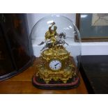 A French style gilt mantle clock with surmount of figure on horse under glass dome, 48cms