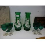 A pair of Mary Gregory green glass vases and seven Victorian green wine glasses