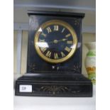 A late Victorian slate mantle clock having gilt decoration with striking movement