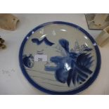 Oriental blue and white plate decorated figure by a house