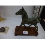 Bronzed model of a horse on a wooden stand