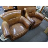 A pair of leather club armchairs on square legs