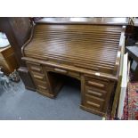 An old oak twin pedestal roll top desk with seven drawers, 121 cms