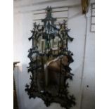 A modern ornate wall mirror decorated figure and birds. 99cms.