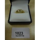 18ct yellow gold band inset with 7 small diamonds, stamped 750, size I/J, gross 3.7g