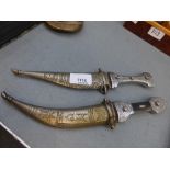2 middle eastern daggers with scabbards, 26cms