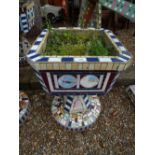 A similar pair of square urns having tiled mosaic decoration 66cms