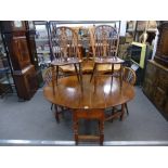 Four antique Windsor wheelback kitchen chairs having elm seats and an oak oval 2 flap dining table