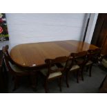 A Victorian mahogany extending dining table on square reeded legs with two leaves, a set of