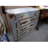 A modern luggage style aluminium chest of drawers with rising lid