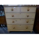 A Victorian stipped pine chest with two short and three long drawers, on turned feet, 106cms