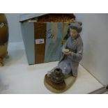 A Lladro figure of kneeling Geisha girl Number 5122