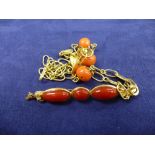 Yellow coloured metal and coral bead necklace and a yellow coloured metal bar brooch set with 3