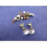 White coloured metal flower spray style brooch inset with various precious stones including 3 opals,