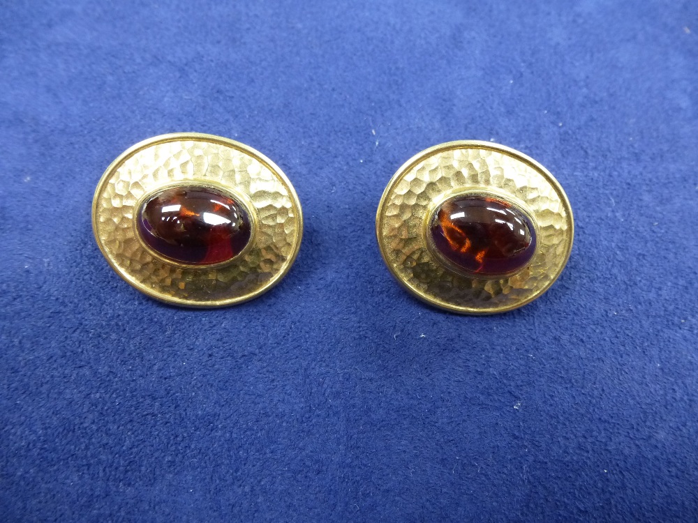 Pair of 9ct yellow gold oval pierced earrings with beaded decoration set with cabochon garnet,