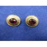 Pair of 9ct yellow gold oval pierced earrings with beaded decoration set with cabochon garnet,