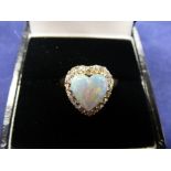 Heart shaped opal and diamond ring on a yellow coloured metal shank, unmarked, size J/K