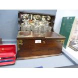 An Edwardian Oak Triple Decanter Tantalus: with lockable cabinet and mirrored back. Three matching