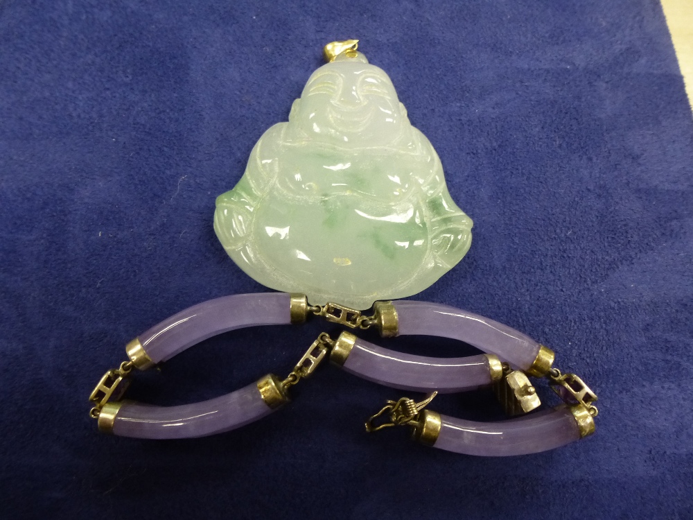 Green hardstone Buddha pendant, 5cm long and a mauve hardstone bracelet