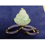 Green hardstone Buddha pendant, 5cm long and a mauve hardstone bracelet