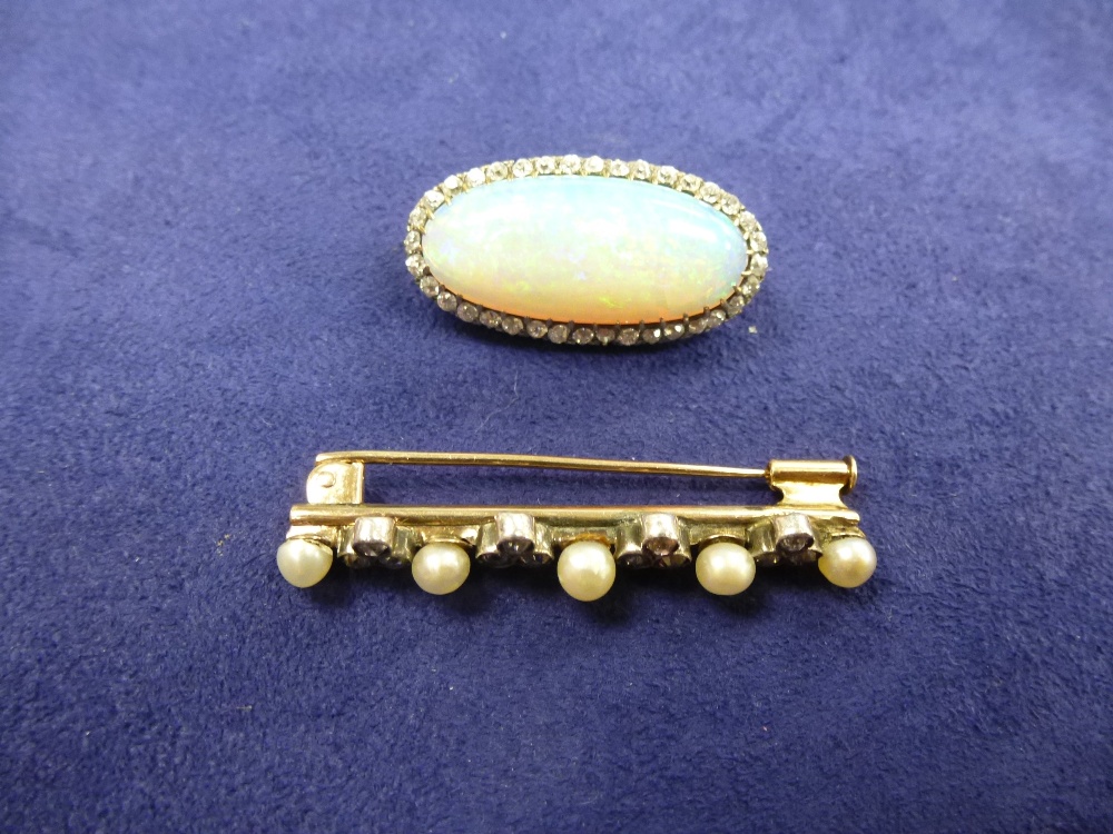 Oval opal and diamond brooch, yellow coloured metal mount, 3cm wide together with a diamond and