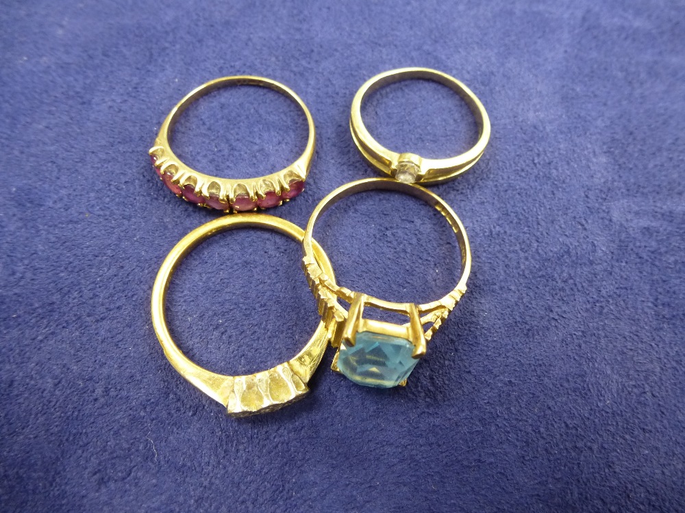 Three 9ct yellow gold stone set rings and a yellow coloured metal ring set with 3 small diamonds,