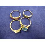 Three 9ct yellow gold stone set rings and a yellow coloured metal ring set with 3 small diamonds,