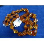 Early 20th Century golden Battic amber bead necklace, each bead with clearly visible fossil