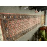 A modern Bokhara runner having repeated central field 305 X 80cms and an Afghan rug 85 X 107cms