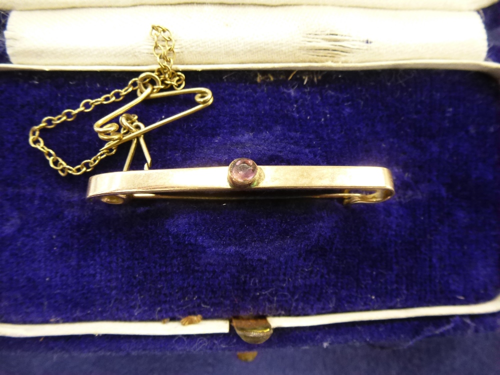 9ct gold tie pin with an Amethyst stone in an original box