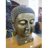 A large resin Buddha head on square base, 68cms