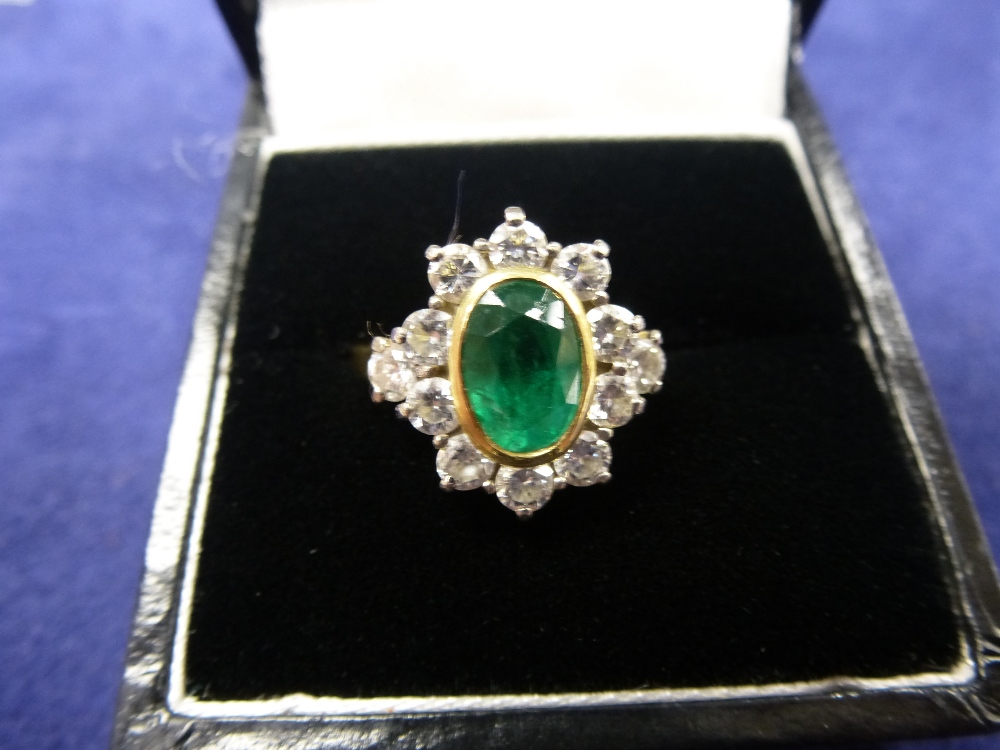 18ct yellow gold cluster style ring with central emerald surrounded by 12 diamonds, shank stamped