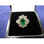 18ct yellow gold cluster style ring with central emerald surrounded by 12 diamonds, shank stamped