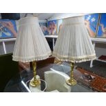 A pair of brass table lamps and shades