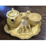 A Ridgeway early morning teaset on fitted tray in brown glaze with gilt rims.