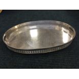 A large silver plated oval drinks tray with gadroon moulded rim above pierced gallery, having