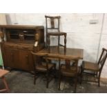 A 50s oak dining room suite with sideboard, draw-leaf dining table & four chairs, with fluted