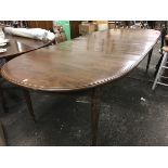 An American Ethan Allen extending dining table, the moulded top with rounded ends and two leaves