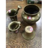 Two heavy brass pestal & mortars; a Victorian eastern brass embossed jardiniere; and a brass