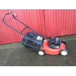 A Champion 35 lawnmower with Briggs & Stratton engine, grass collecting box, etc.