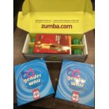A boxed Zumba fitness set with a pair of shaker dumbbells, complete total-body transformation system
