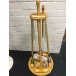 A beech croquet set on stand, complete with instructions, balls, hoops, mallets, etc.