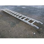 An aluminium extension ladder in two sections with hinged feet and ribbed treads.