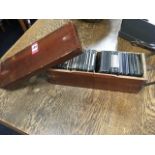 A Victorian mahogany box of 3.25in glass slides, the subjects varying from architectural